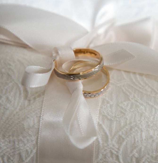 Alliances de mariage sur un coussin blanc en dentelle pour service de transport de luxe en Provence.
